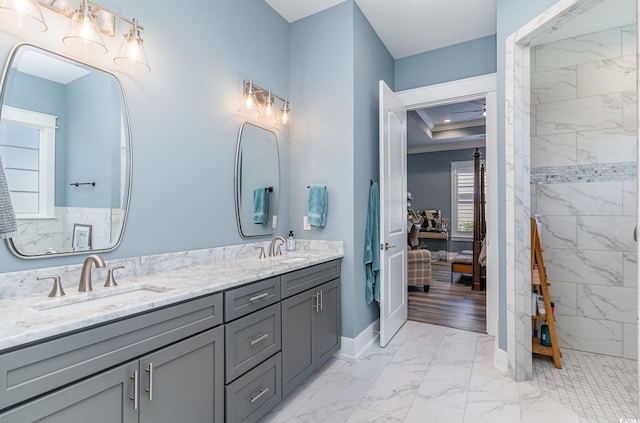 bathroom with a tile shower, crown molding, vanity, and a healthy amount of sunlight