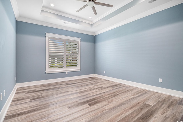 1201 Surf Pointe Dr, North Myrtle Beach, SC 29582 - empty room featuring ornamental molding, a tray ceiling, wood finished floors, ceiling fan, and baseboards