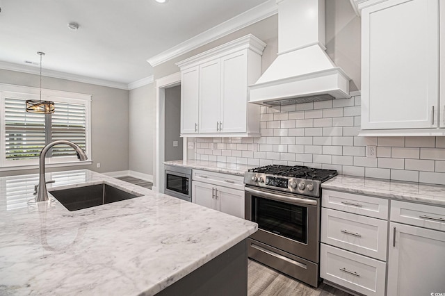 1201 Surf Pointe Dr, North Myrtle Beach, SC 29582 - kitchen featuring appliances with stainless steel finishes, custom range hood, a sink, ornamental molding, and white cabinets