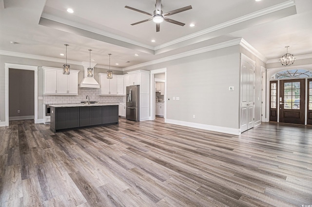 1201 Surf Pointe Dr, North Myrtle Beach, SC 29582 - unfurnished living room with a sink, a tray ceiling, a ceiling fan, dark wood finished floors, and recessed lighting
