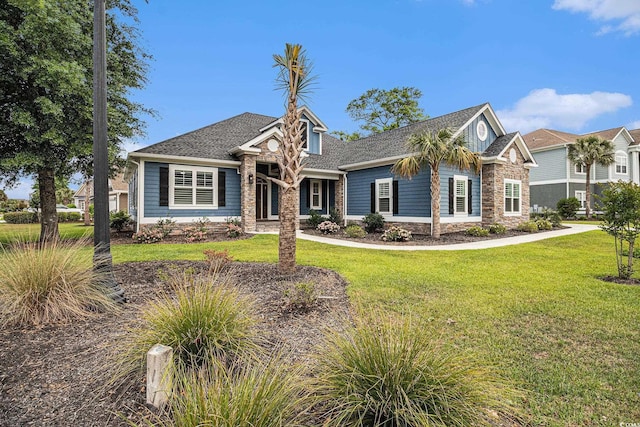 1201 Surf Pointe Dr, North Myrtle Beach, SC 29582 - craftsman house with stone siding, a front yard, and roof with shingles