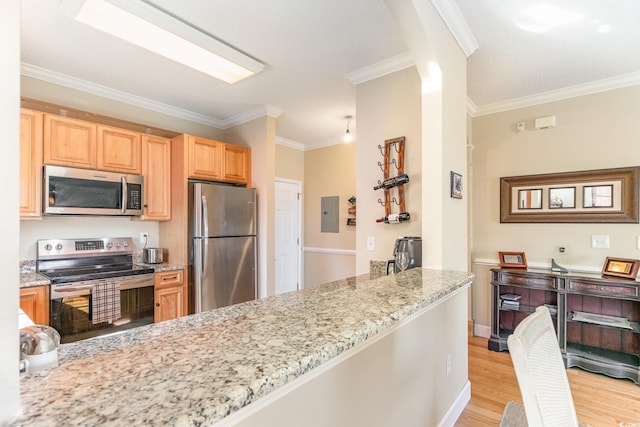 kitchen with a peninsula, light wood-style flooring, light stone countertops, and appliances with stainless steel finishes