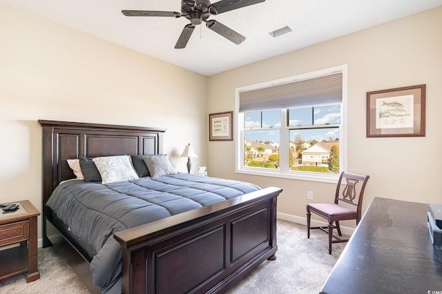 bedroom with light carpet, visible vents, a ceiling fan, and baseboards