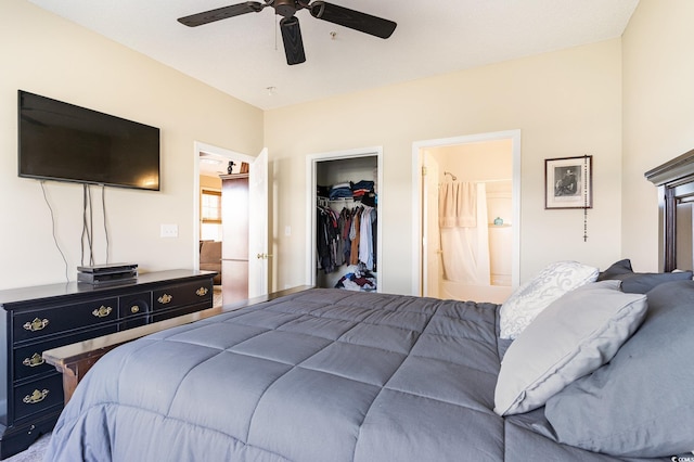 bedroom with a spacious closet, a closet, ensuite bathroom, and ceiling fan