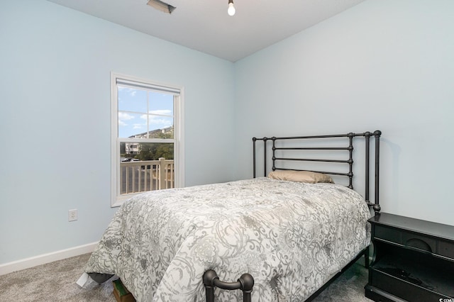 carpeted bedroom with baseboards