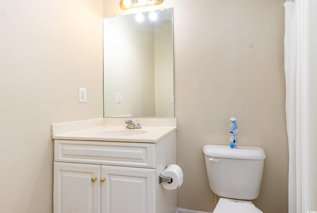 bathroom featuring toilet and vanity