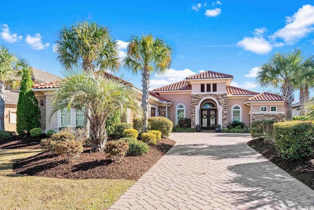 mediterranean / spanish-style house featuring french doors