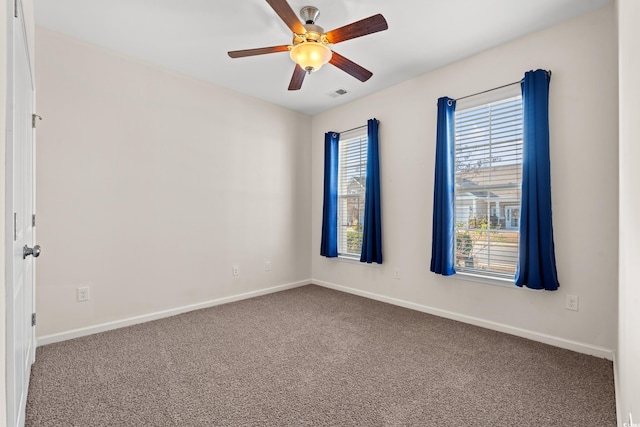 empty room with ceiling fan and carpet floors