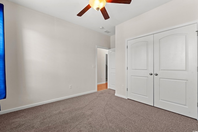 unfurnished bedroom with carpet floors, a closet, and ceiling fan