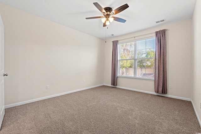 carpeted spare room featuring ceiling fan