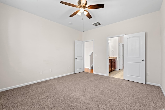 unfurnished bedroom with light carpet, ensuite bath, and ceiling fan