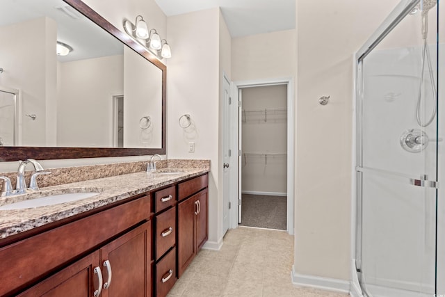 bathroom with tile patterned flooring, vanity, and an enclosed shower