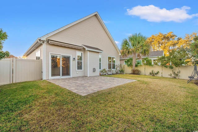 back of house featuring a patio area and a yard