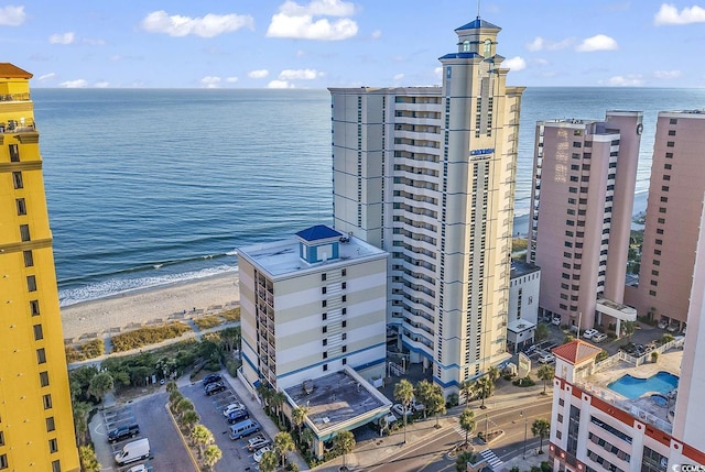 bird's eye view featuring a water view and a beach view