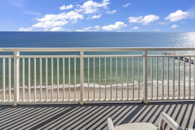 balcony with a view of the beach and a water view