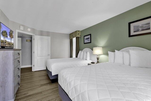 bedroom featuring baseboards and wood finished floors