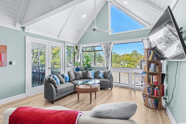 sunroom / solarium featuring lofted ceiling with beams, wood ceiling, and french doors