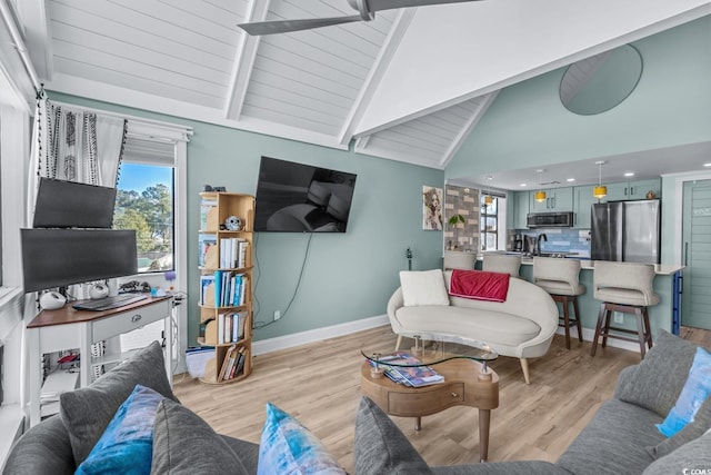 living room featuring beamed ceiling, light wood-type flooring, and high vaulted ceiling