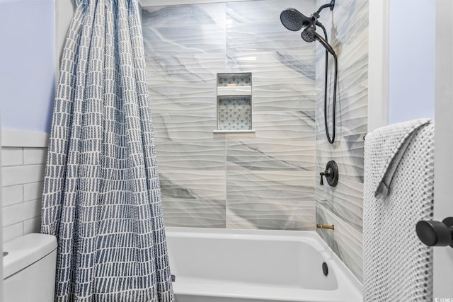 bathroom with shower / bath combo with shower curtain, tile walls, and toilet