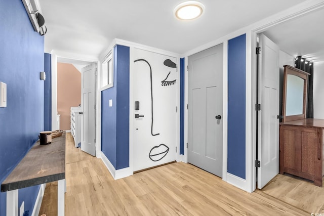 interior space featuring washer and clothes dryer and light wood-type flooring