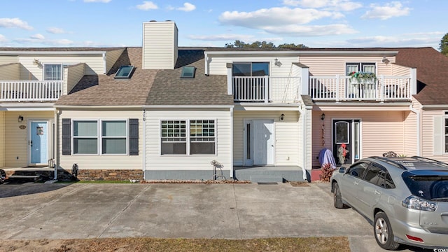 view of front of house with a balcony