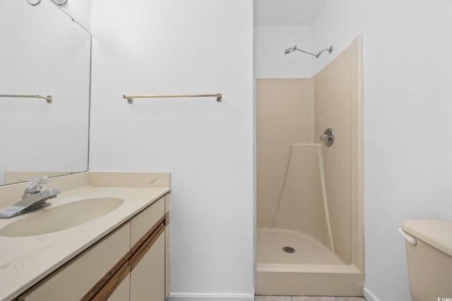 bathroom with vanity, toilet, and walk in shower