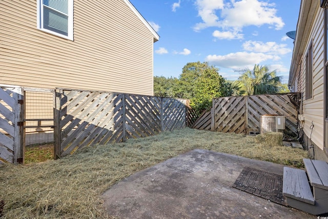 view of yard featuring central AC and a patio