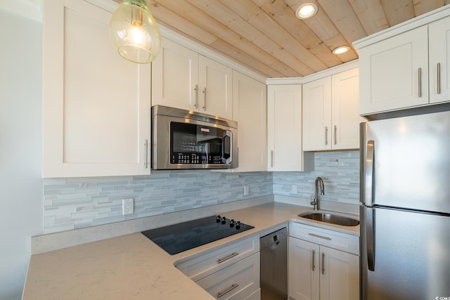 kitchen featuring decorative backsplash, appliances with stainless steel finishes, wood ceiling, sink, and white cabinetry