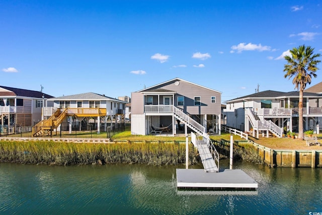 rear view of house featuring a water view