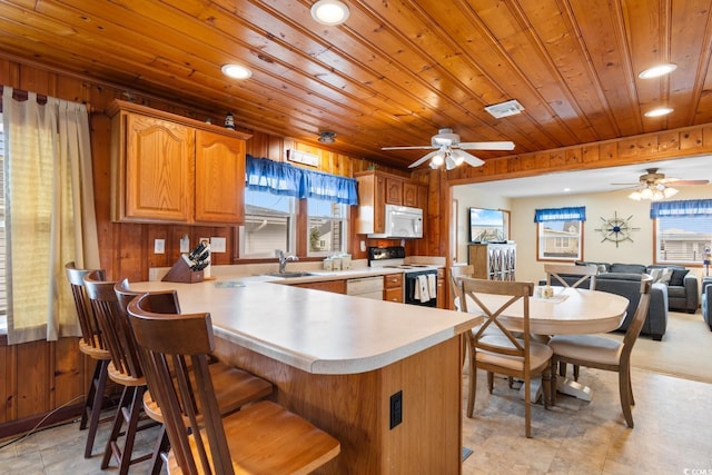 kitchen with kitchen peninsula, plenty of natural light, wood ceiling, and white appliances