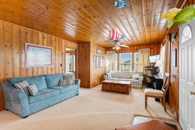 310 46th Ave N, North Myrtle Beach, SC 29582 - living room featuring wood ceiling, wood walls, plenty of natural light, carpet flooring, and ceiling fan