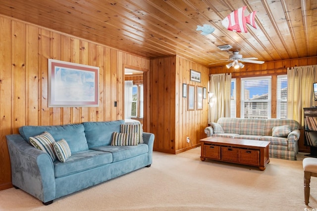 310 46th Ave N, North Myrtle Beach, SC 29582 - carpeted living room featuring wooden ceiling, wood walls, and ceiling fan