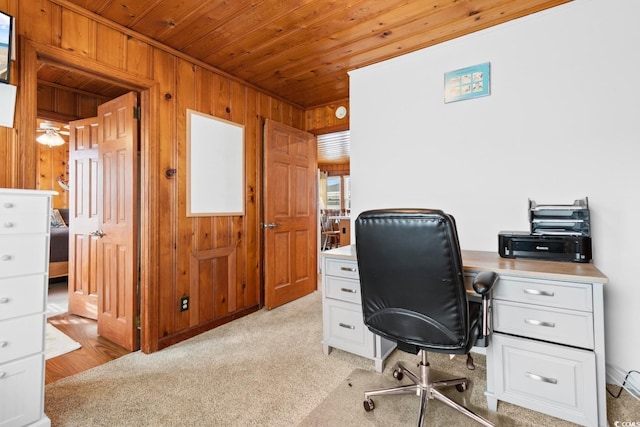 carpeted home office featuring wooden ceiling and wooden walls