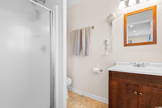 bathroom with tile patterned flooring, vanity, toilet, and a shower with shower door