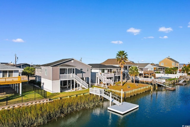 310 46th Ave N, North Myrtle Beach, SC 29582 - dock area featuring a water view, a fenced backyard, a residential view, and stairway
