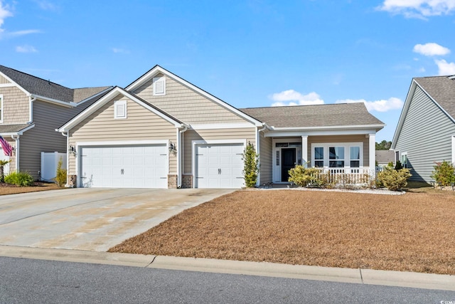 view of front of property with a porch and a garage