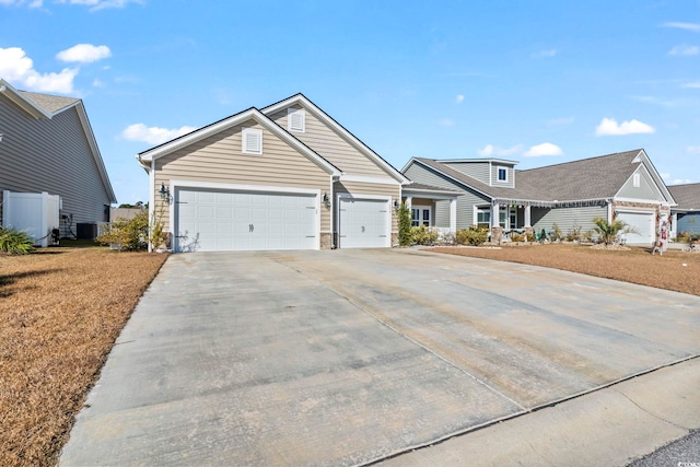 view of front of home with a garage and cooling unit