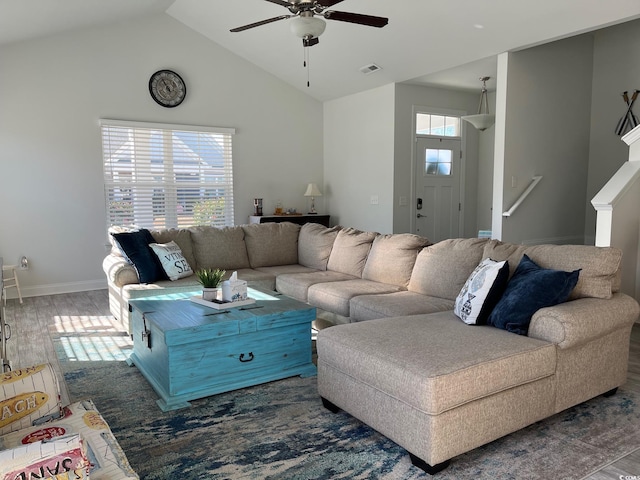 living room with plenty of natural light, dark wood-type flooring, and ceiling fan