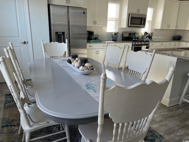 dining area with dark wood finished floors