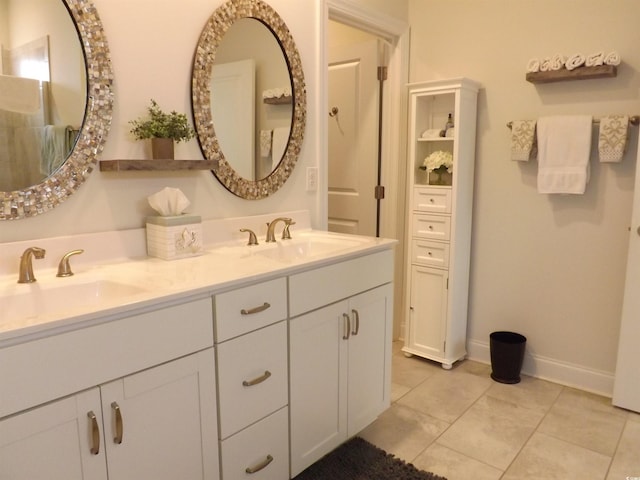 full bathroom with double vanity, a sink, and tile patterned floors