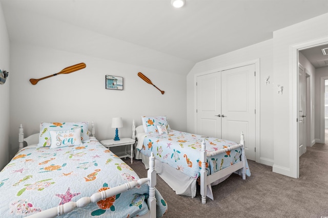 carpeted bedroom with a closet, baseboards, vaulted ceiling, and visible vents