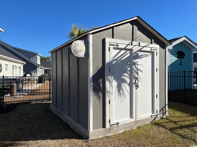 view of shed featuring fence