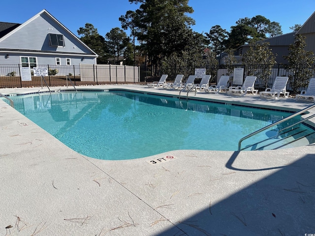 community pool featuring a patio area and fence