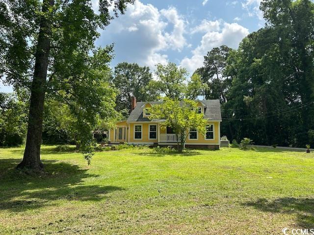 2708 Main St, Loris, SC 29569 - view of front of house with a front lawn and a chimney