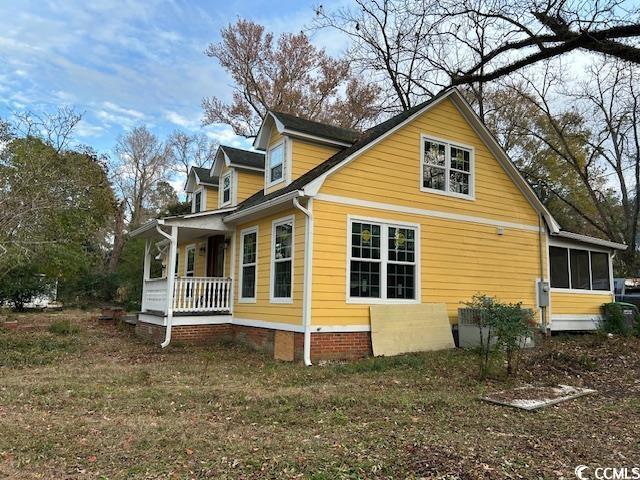 view of side of property with covered porch