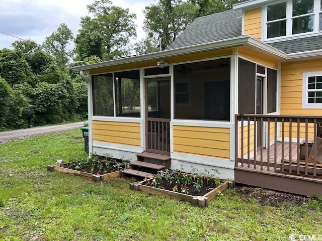 2708 Main St, Loris, SC 29569 - wooden terrace featuring a sunroom and a lawn