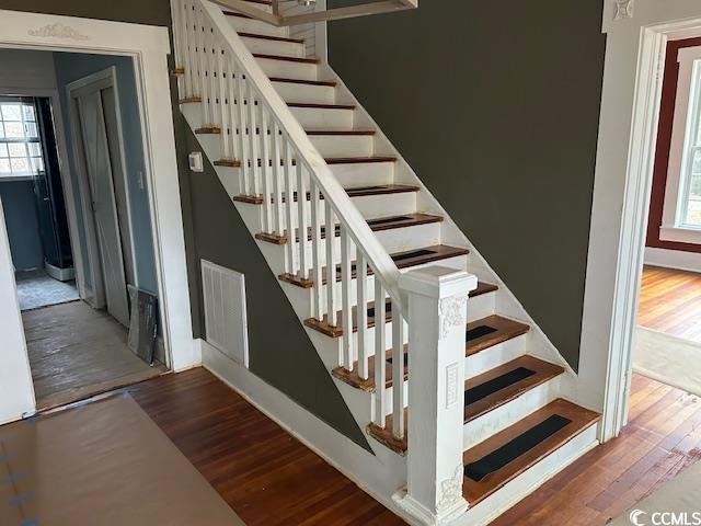 stairway with hardwood / wood-style floors