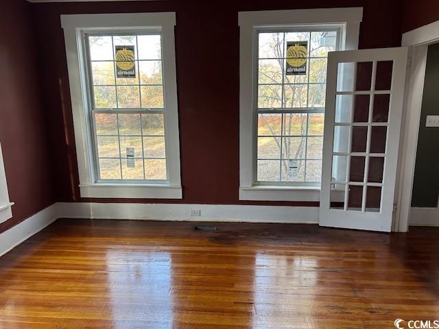 interior space featuring hardwood / wood-style flooring and a healthy amount of sunlight