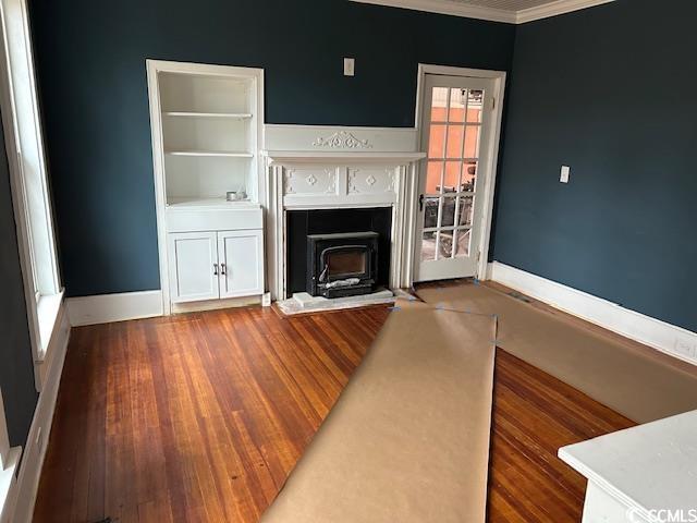 unfurnished living room featuring ornamental molding and hardwood / wood-style floors