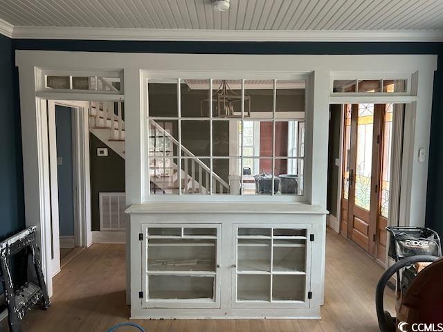 doorway to outside with crown molding and hardwood / wood-style floors